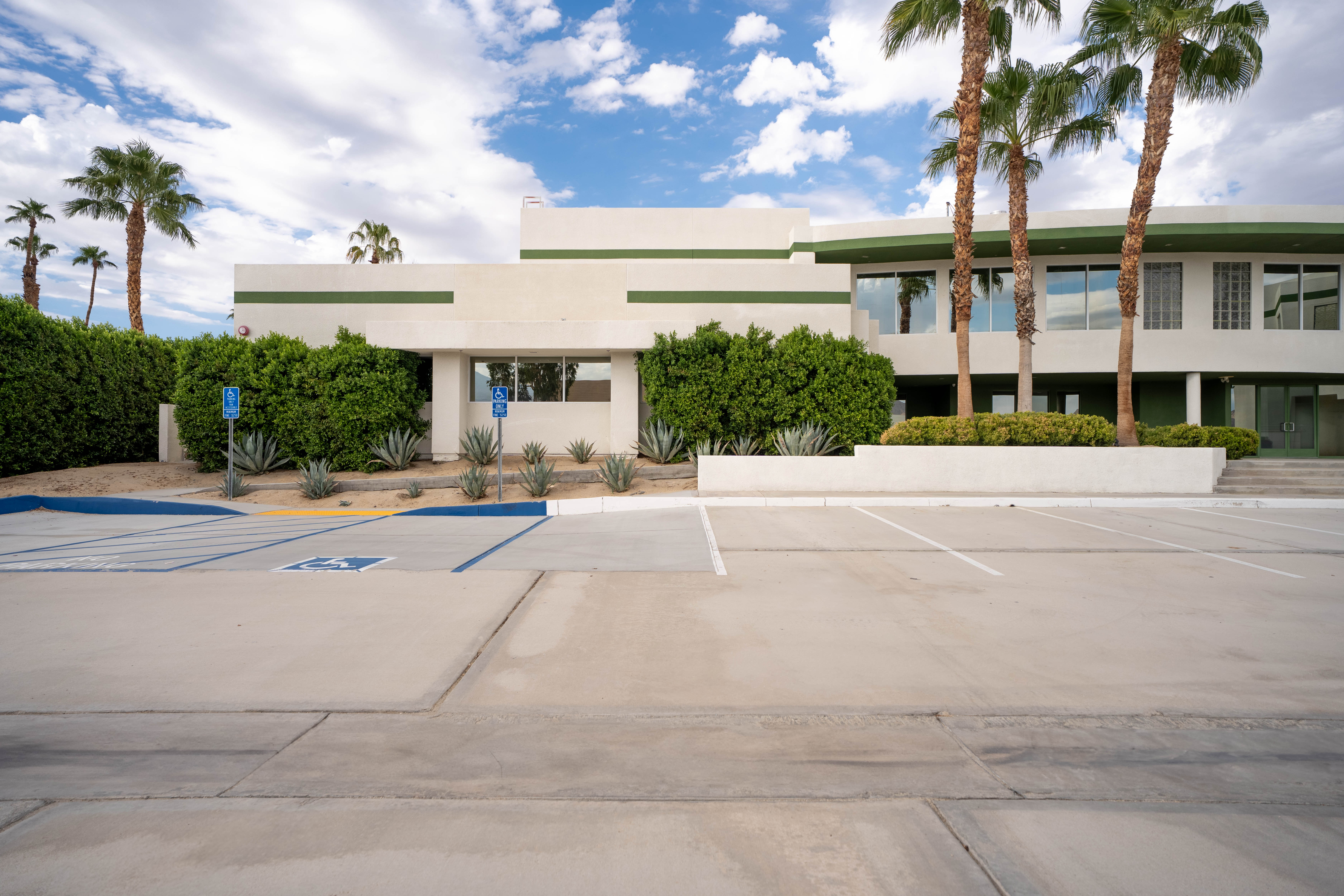 42650 Melanie Place exterior — retail building with palm trees and parking